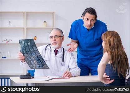 Two doctors examining young woman 