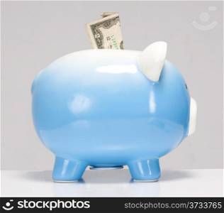 Two Dollar Bill Stuck in the Piggy Bank on white