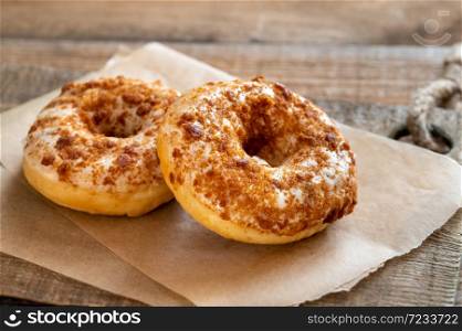 Two donuts on the wooden board