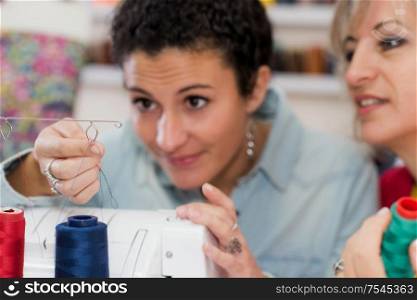 two dressmaker working on a sewing machine