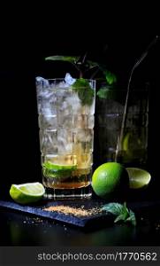 two drinks with lime on a black background