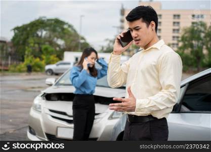 Two drivers call insurance after a car accident before taking pictures and sending insurance. Online car accident insurance claim idea after submitting photos and evidence to an insurance company.