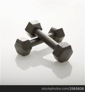 Two dumbbells leaning together.