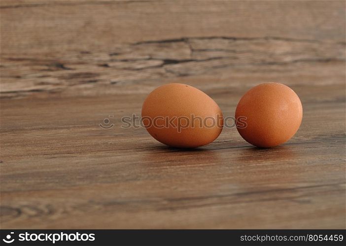 Two eggs isolated on a wooden background