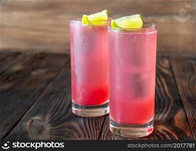 Two El Diabo Cocktails garnished with lime wedges