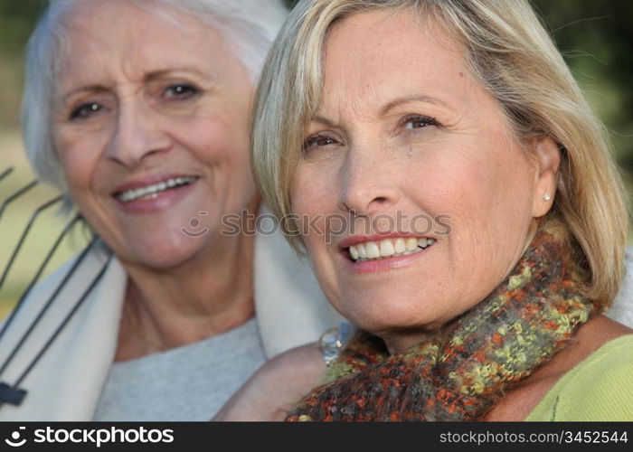 Two elderly ladies sat in the garden together