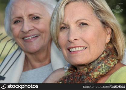 Two elderly ladies sat in the garden together