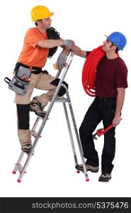 two electrician stood with step-ladder