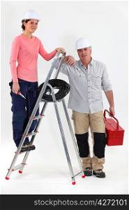 Two electricians with a ladder