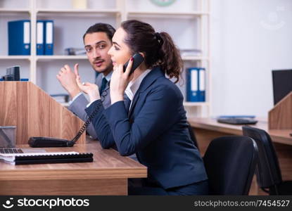 Two employees working in the office 