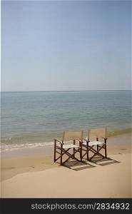 Two empty chairs on a beach