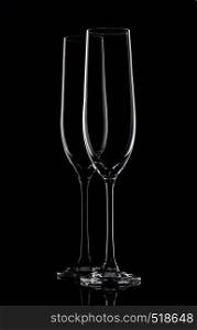 Two empty champagne glasses on black background. Two champagne glasses on black