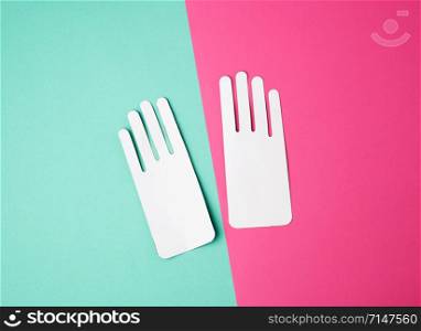 two empty paper white patterns for gloves on a colored background