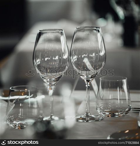 Two empty wine glasses on table in restaurant