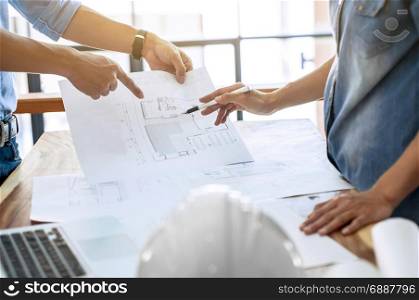 two engineers discussion on architectural project at construction site at modern office