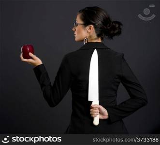Two Faced Woman Holds Apple and Large Kitchen Knife Blade