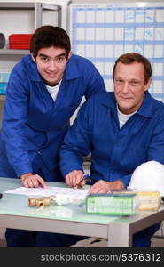 Two factory workers checking inventory