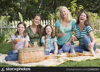Two families having picnic in a park