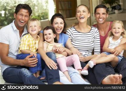 Two Families Sitting Outside House