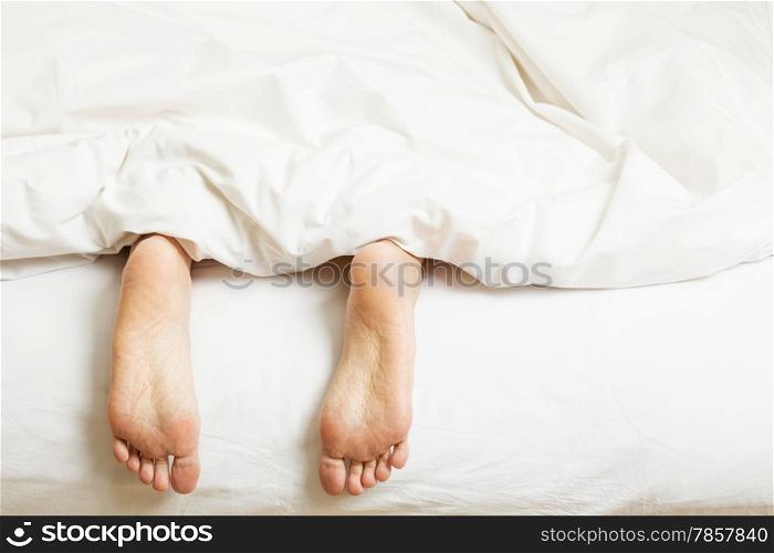 two feet in a bed