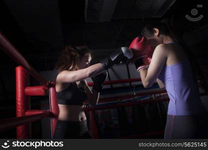 Two female boxers boxing in the boxing ring in Beijing, China