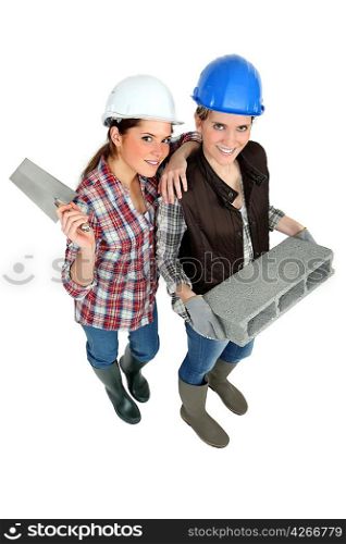 two female builders posing