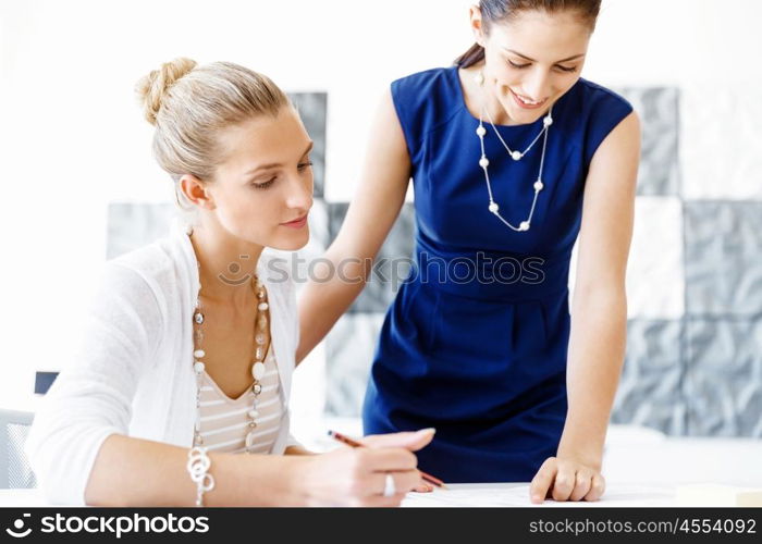 Two female colleagues in office. Two female colleagues working together in office