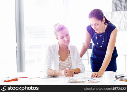 Two female colleagues in office. Two female colleagues working together in office