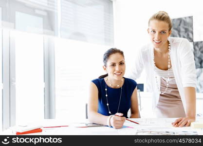 Two female colleagues in office. Two female colleagues working together in office