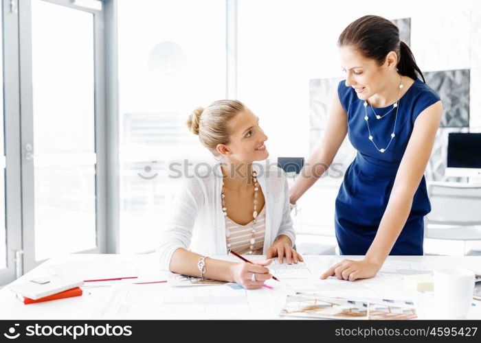 Two female colleagues in office. Two female colleagues working together in office