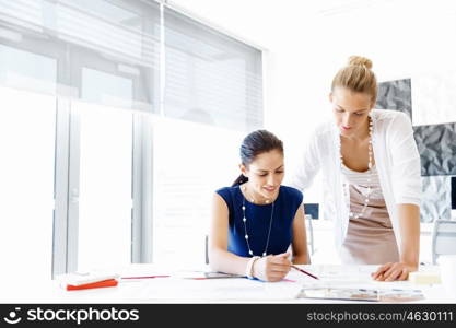 Two female colleagues in office. Two female colleagues working together in office