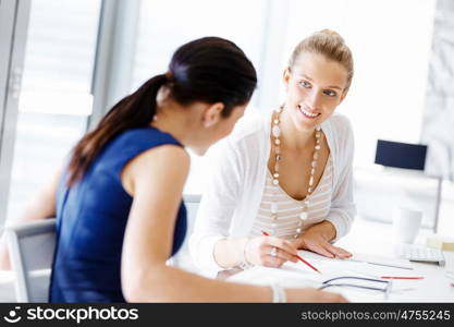 Two female colleagues in office. Two female colleagues working together in office