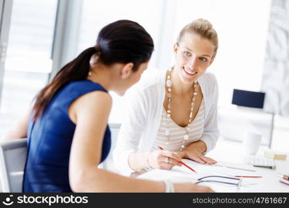 Two female colleagues in office. Two female colleagues working together in office