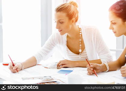 Two female colleagues in office. Two female colleagues working together in office