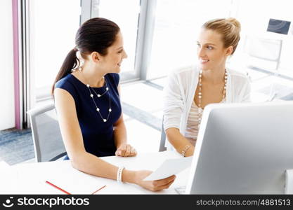 Two female colleagues in office. Two female colleagues working together in office