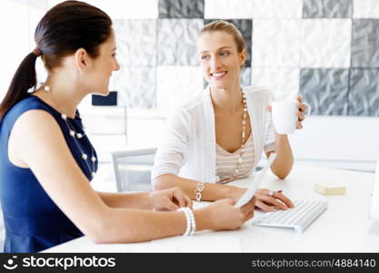 Two female colleagues in office. Two female colleagues working together in office