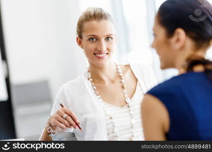 Two female colleagues in office. Two female colleagues working together in office