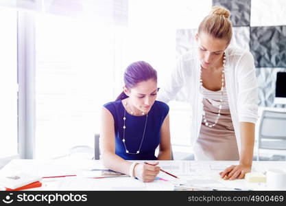 Two female colleagues in office. Two female colleagues working together in office