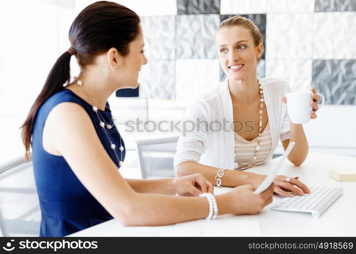 Two female colleagues in office. Two female colleagues working together in office