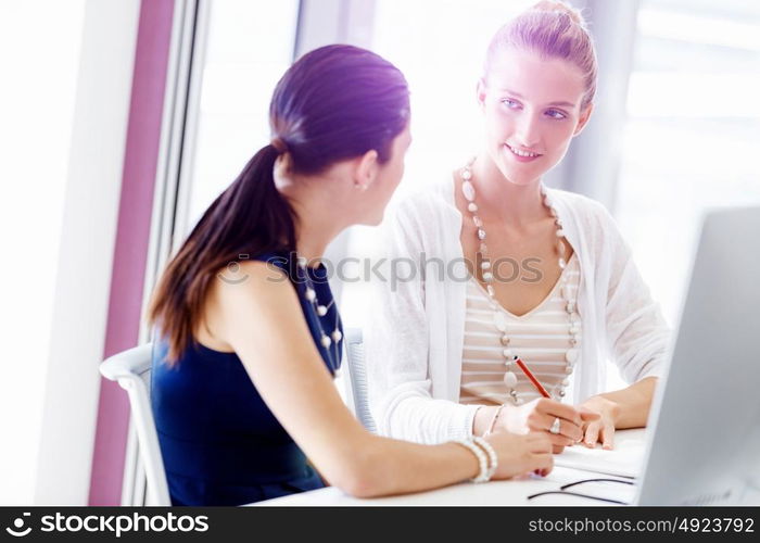 Two female colleagues in office. Two female colleagues working together in office