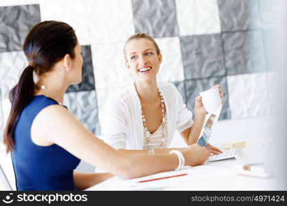 Two female colleagues in office. Two female colleagues working together in office