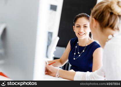 Two female colleagues in office. Two female colleagues working together in office