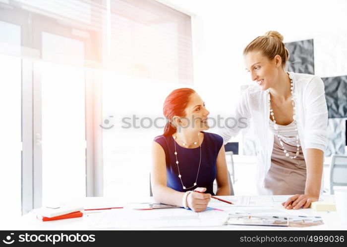 Two female colleagues in office. Two female colleagues working together in office