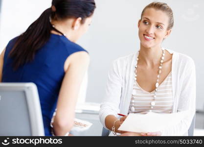 Two female colleagues in office. Two female colleagues working together in office