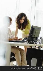 Two female colleagues working in office