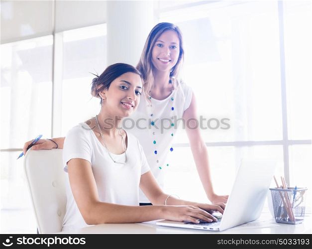 Two female collegues working together in an office