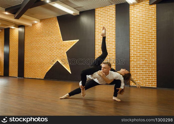 Two female contemporary dance performers poses in studio. Dancers training in class, modern elegance dancing. Two contemporary dance performers poses in studio