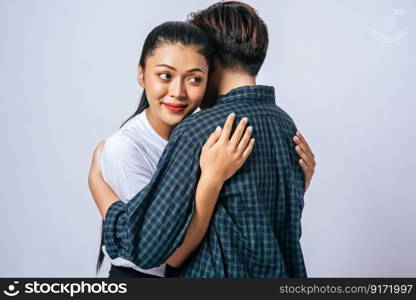 Two female couples standing and hugging each other.