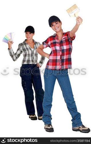 Two female decorators choosing paint color