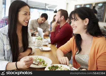 Two Female Friends Friends Meeting For Lunch In Coffee Shop